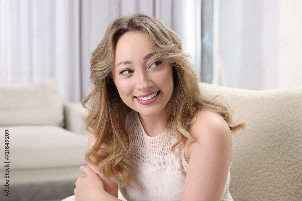 Portrait of smiling woman with curly hair at home Portrait of smiling woman with curly hair at home