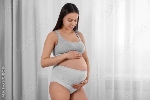 Free Download Beautiful pregnant woman in comfortable maternity underwear indoors - GFXLoad