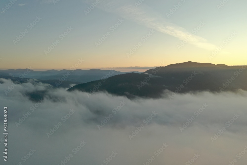 Aerial view of beautiful mountains covered with fluffy clouds in morning Aerial view of beautiful mountains covered with fluffy clouds in morning