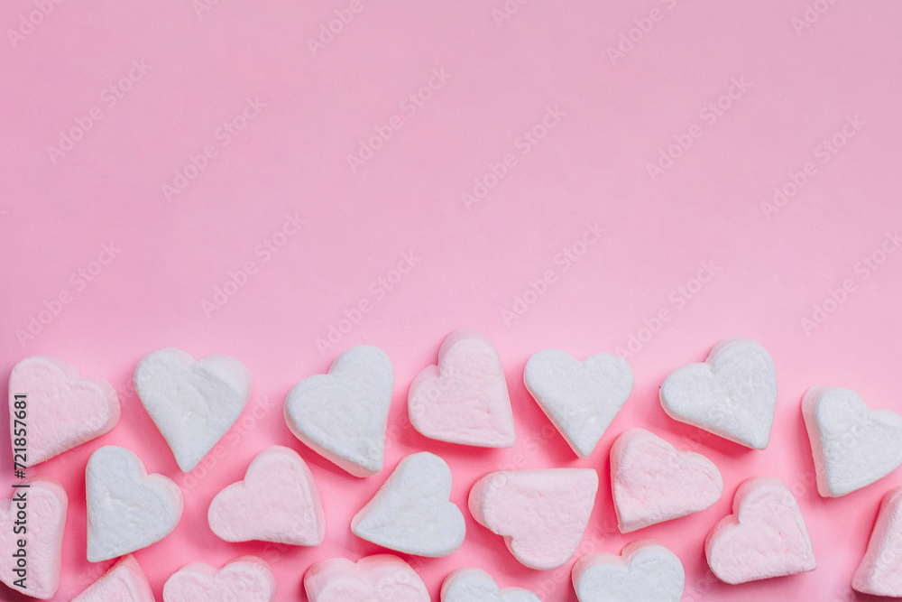 Pink marshmelow hearts on a pink background. The concept of Valentine's Day. February 14 Pink marshmelow hearts on a pink background. The concept of Valentine's Day. February 14