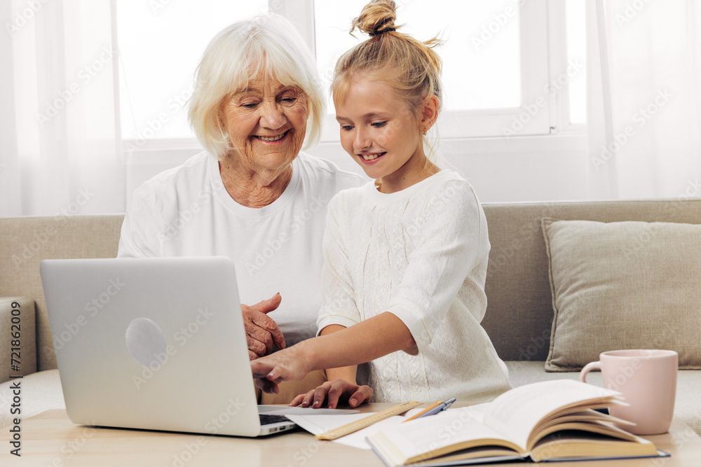 Togetherness selfie sofa bonding smiling laptop child family grandmother education hugging granddaughter
