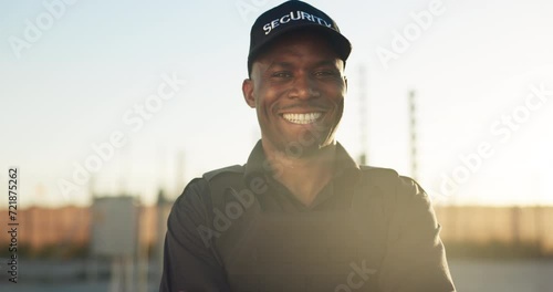 Happy, security guard and portrait of man outdoor working in safety, protection and surveillance of property. African, person and professional bodyguard monitoring real estate at access control fence photo