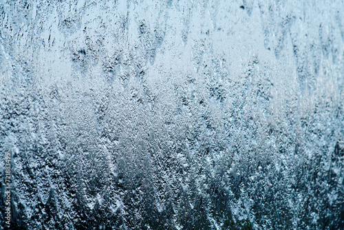 Fototapeta Naklejka Na Ścianę i Meble -  Blue of water on a sunny day background. Streams of water on a glass waterfall flow down creating a beautiful background.