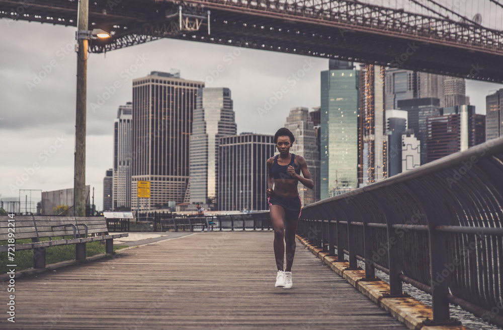 Athlete woman training in the morning at sunrise in New york city, Brooklyn in the background Athlete woman training in the morning at sunrise in New york city, Brooklyn in the background