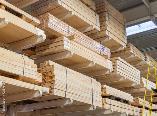 Wooden boards and slabs in the warehouse of the hardware store or in a construction hypermarket. Construction sheet materials stored on cantilever rack in joinery workshop. Sale of materials.