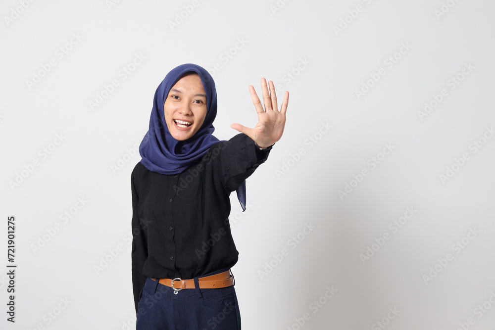 Portrait of excited Asian hijab woman in casual suit showing and pointing up with fingers number five while smiling confident and happy. Businesswoman concept. Isolated image on white background Portrait of excited Asian hijab woman in casual suit showing and pointing up with fingers number five while smiling confident and happy. Businesswoman concept. Isolated image on white background