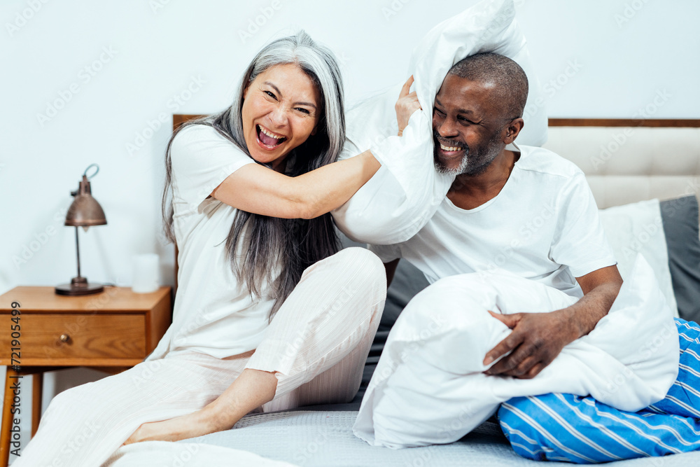 Obraz premium Cinematic image of an happy multiethnic senior couple.