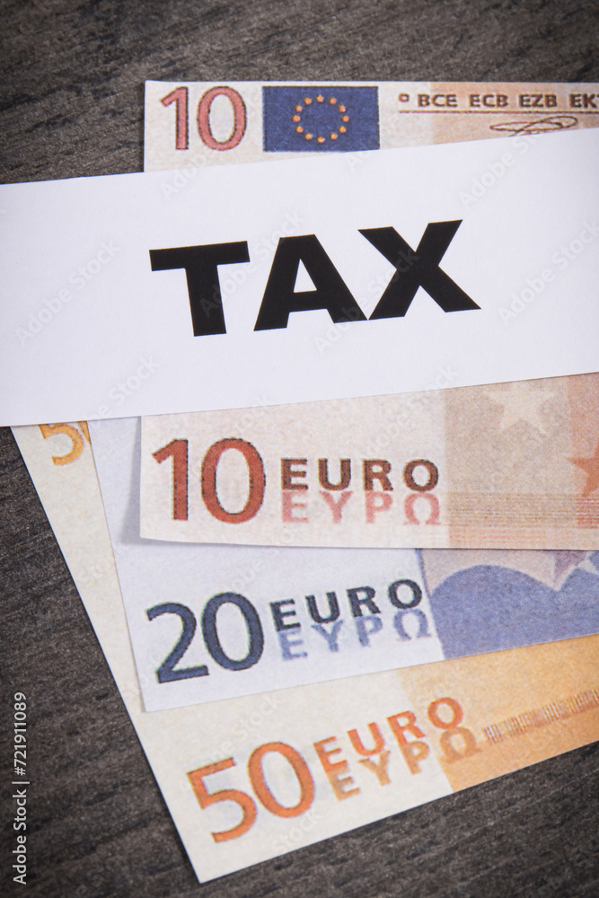 Obraz premium Inscription tax and euro banknotes. Time of calculating, return or tax payment