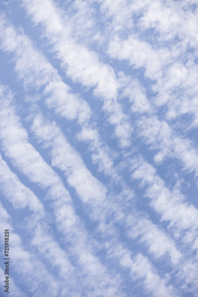 Minimalistic cloudy daytime blue sky with cirrus rhythmic clouds for background