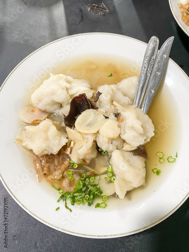 Tekwan is a typical Palembang food meatballs made from a mixture of fish meat and tapioca served with vermicelli, sliced jicama, mushrooms, sprinkled spring onions, celery and fried shallots. photo