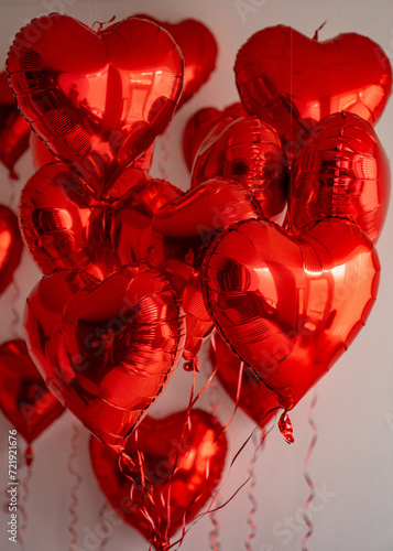 a pile of red balloons and wrapped presents
