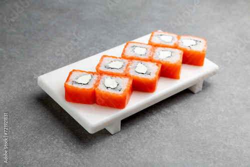 Japanese Sushi roll Philadelphia Max on a white stand, gray background