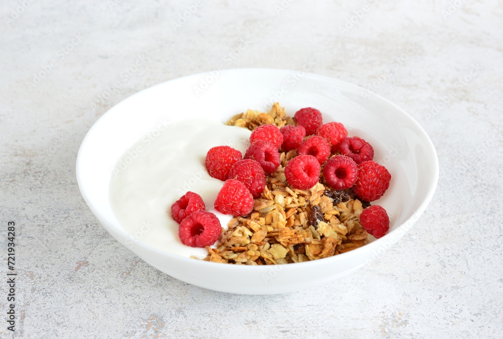muesli with yoghurt and fresh raspberries in bowl close up muesli with yoghurt and fresh raspberries in bowl close up