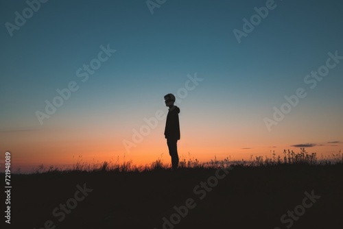 A solitary figure basks in the glow of the rising sun, their silhouette a symbol of determination and freedom in the vast open field © ChaoticMind