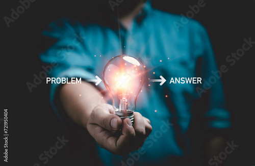 Businessman holing glowing lightbulb for creative thinking idea and problem solving until get solution and answer concept.