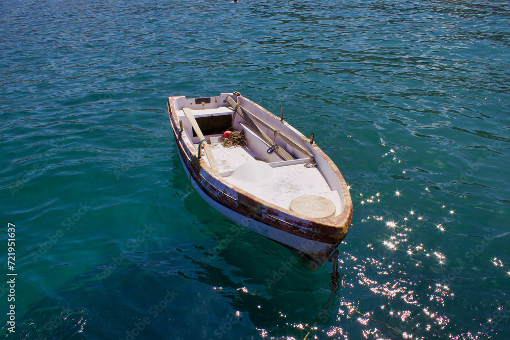 Old Small Fishing Greek Boat on the coastline of Zeus Bay. Naxos, Greece. 