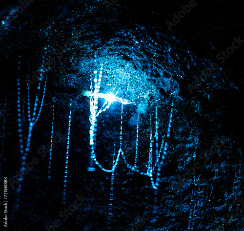 Glowworms in Ruakuri caves in Waitomo, New Zealand. These are actually maggots, but were renamed to worms for marketing reasons.. photo