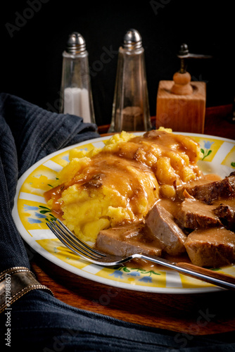 Stewed pork tongues in mustard gravy. photo