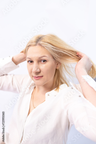 Portrait of smiling positive woman looking up isolated on white background. Beautiful girl with healthy hair posing for picture. Healthy lifestyle concept.