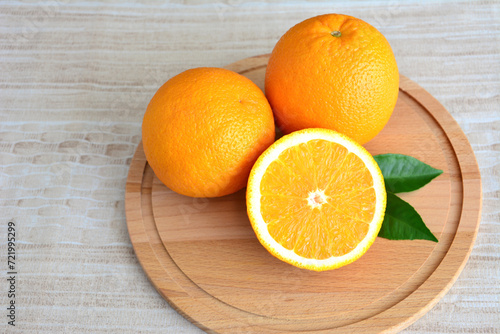 group of organic oranges on the round board isolated close up   