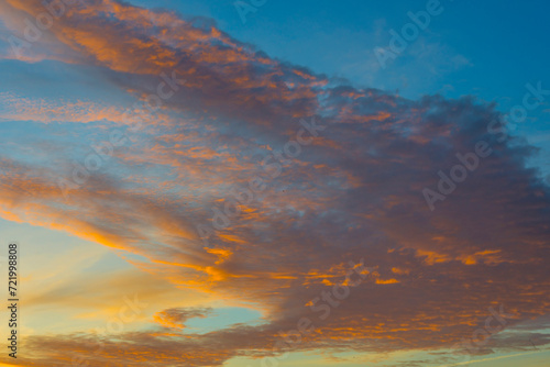 Orange clouds in a blue sky at sunrise in winter, Almere, Flevoland, Netherlands, January 28, 2024