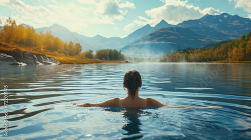 young woman swimming at sunset in a romantic calm lake