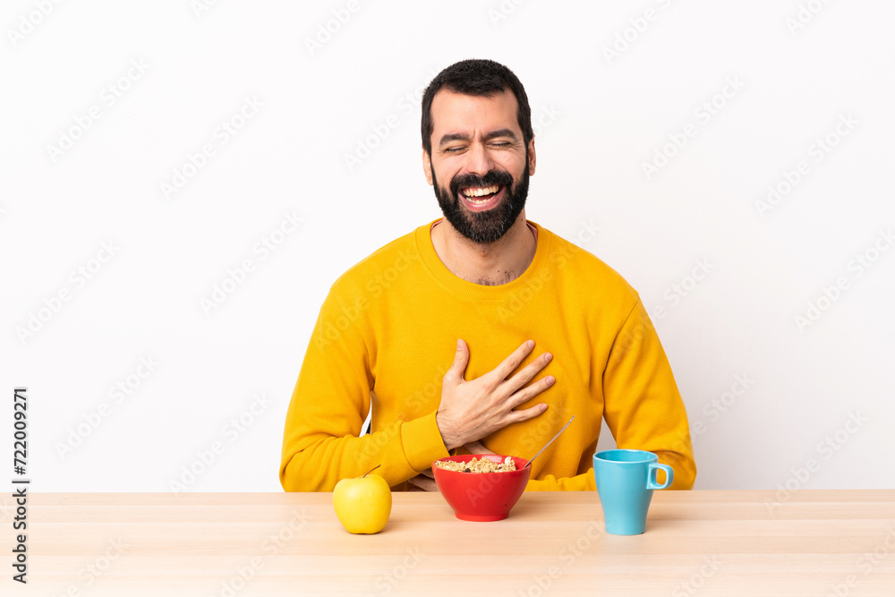 Caucasian man having breakfast in a table smiling a lot. Caucasian man having breakfast in a table smiling a lot.