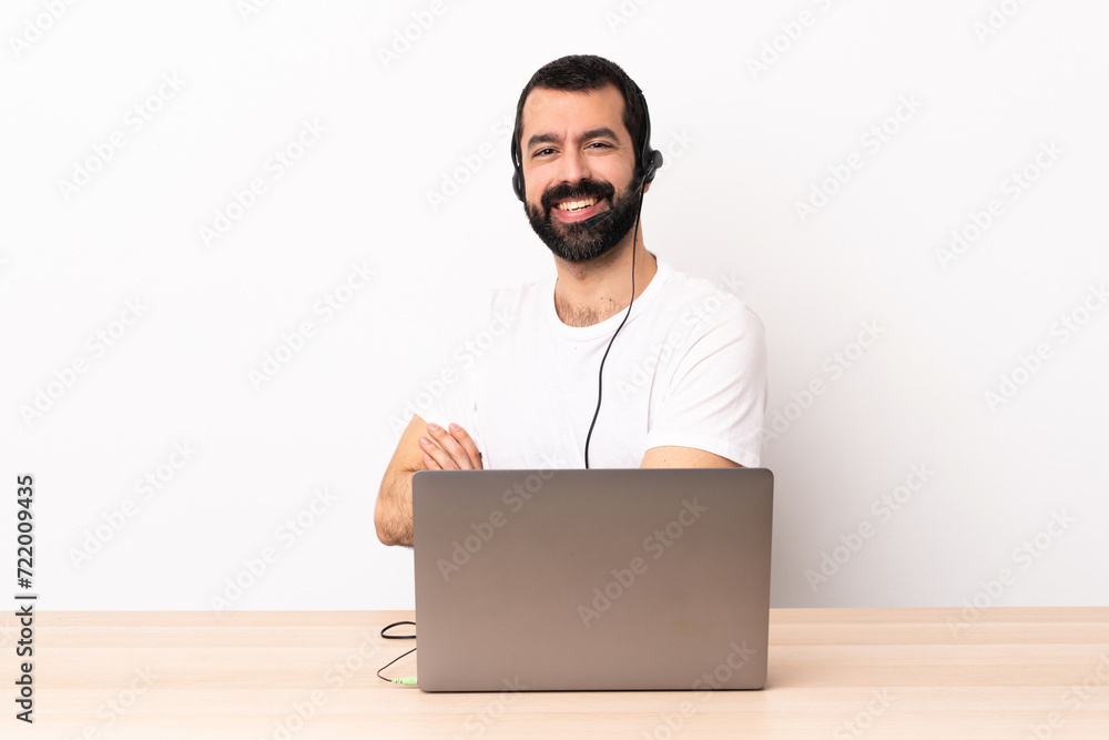 Telemarketer caucasian man working with a headset and with laptop with arms crossed and looking forward. Telemarketer caucasian man working with a headset and with laptop with arms crossed and looking forward.