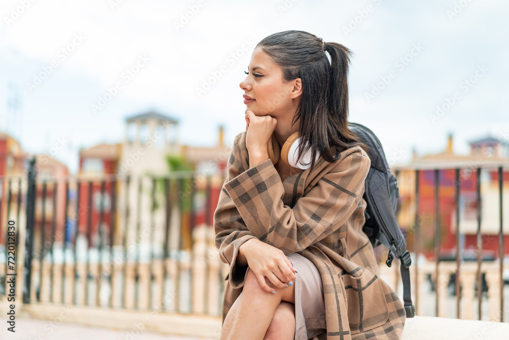 Fototapeta premium Young pretty woman at outdoors with happy expression