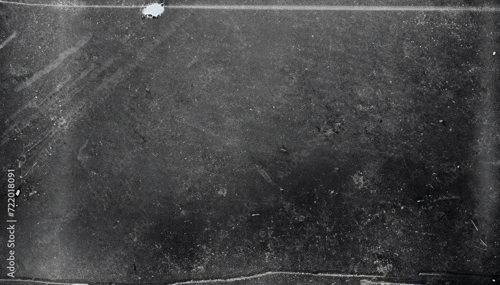 Obraz premium Dusty scratched and scanned old film texture for banner on black asphalt