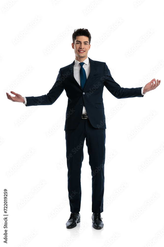 full body picture of elegant businessman in navy blue suit opening arms full body picture of elegant businessman in navy blue suit opening arms