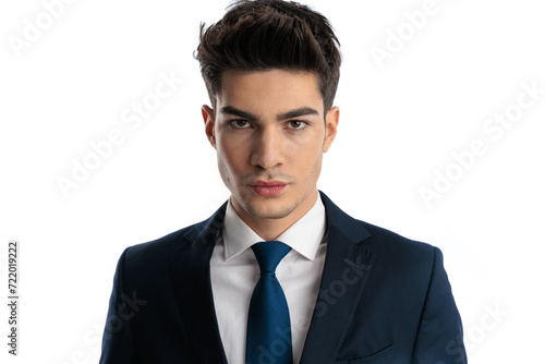 portrait of sexy elegant man in navy blue suit looking at camera