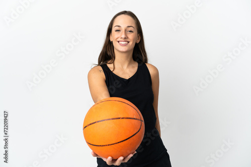 Young hispanic woman over isolated white background playing basketball © luismolinero