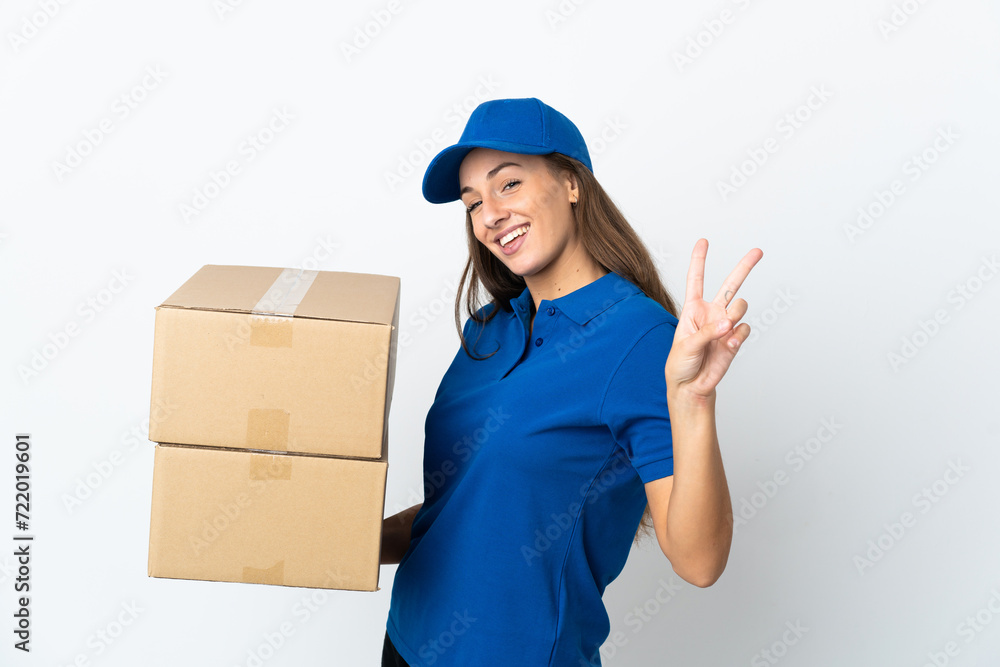 Young delivery woman over isolated white background smiling and showing victory sign Young delivery woman over isolated white background smiling and showing victory sign