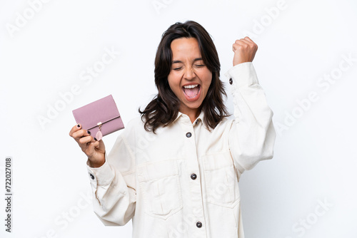 Young hispanic woman holding wallet isolated on white background celebrating a victory