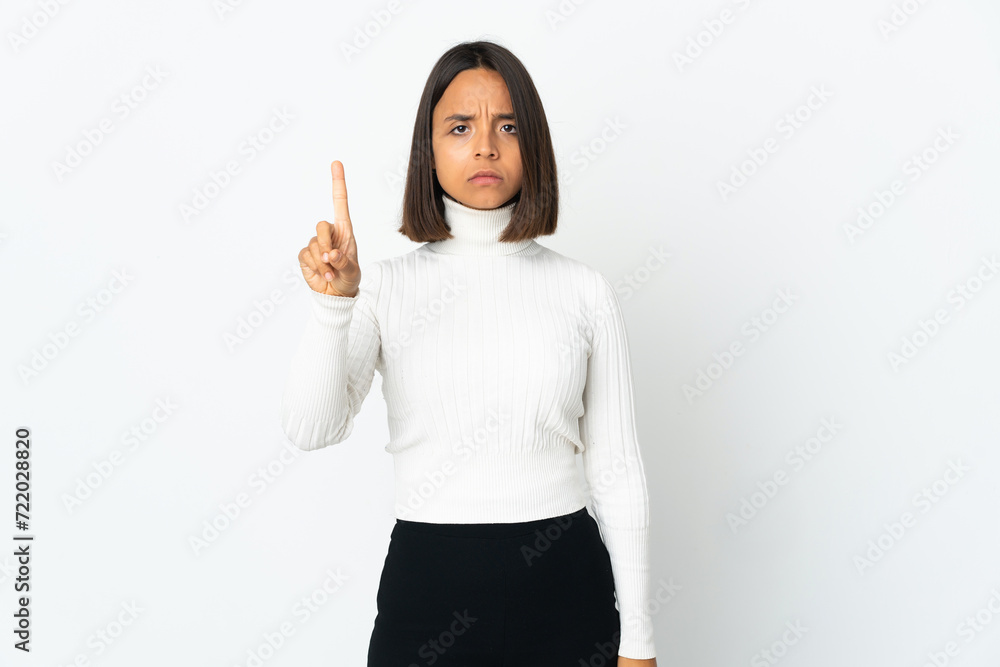 Young latin woman isolated on white background counting one with serious expression Young latin woman isolated on white background counting one with serious expression