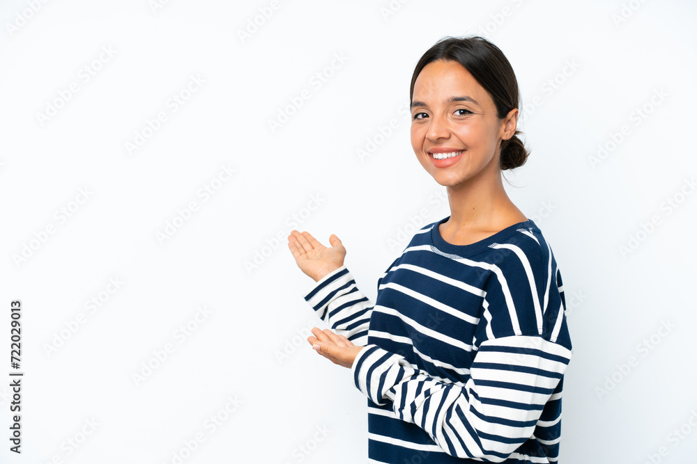 Young hispanic woman isolated on white background extending hands to the side for inviting to come Young hispanic woman isolated on white background extending hands to the side for inviting to come