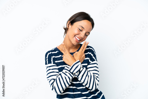 Young hispanic woman isolated on white background smiling and showing victory sign