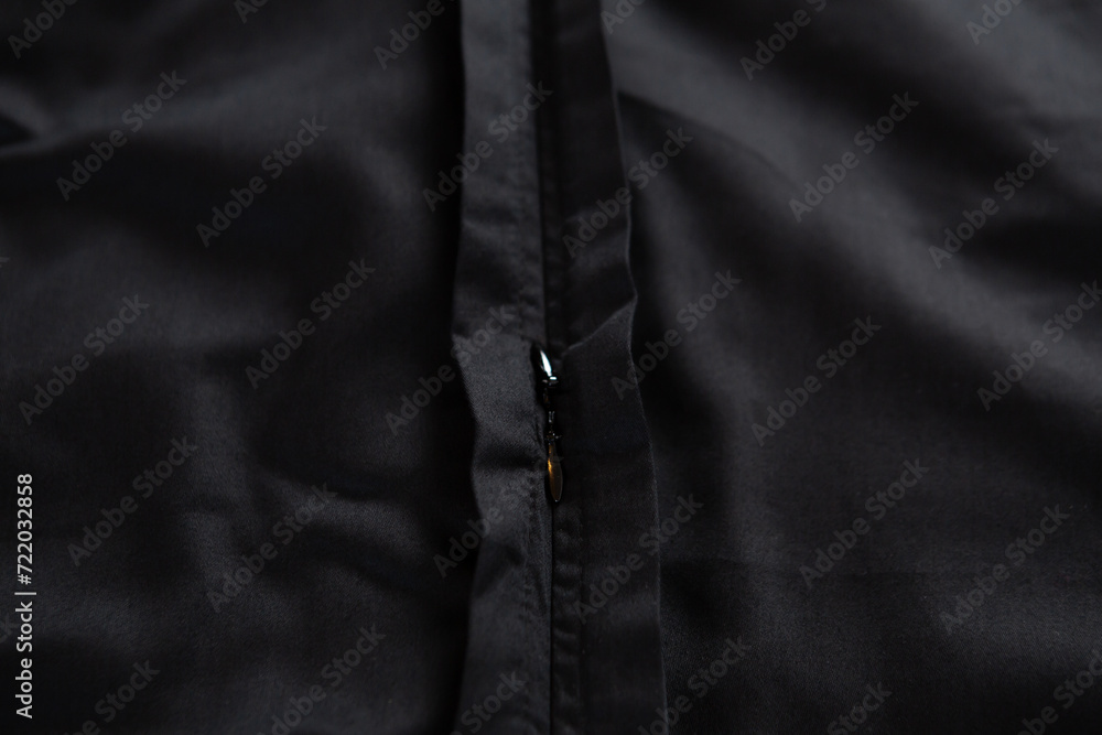 Texture of black crumpled cotton fabric with zipper Texture of black crumpled cotton fabric with zipper