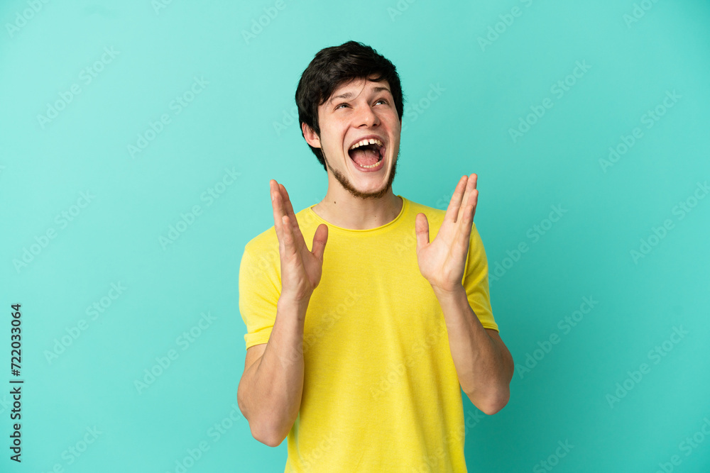 Young Russian man isolated on blue background with surprise facial expression Young Russian man isolated on blue background with surprise facial expression
