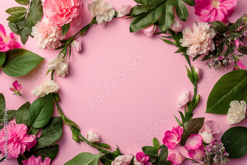 Spring flowers on pink background with copy space. Woman's day or Mother's day concept.