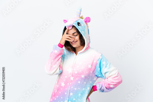 Young caucasian woman wearing a unicorn pajama isolated on white background laughing