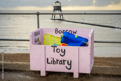 A Toy box with the Dovercourt Low Lighthouse in the background, seen in Harwich, Essex, England, UK photo