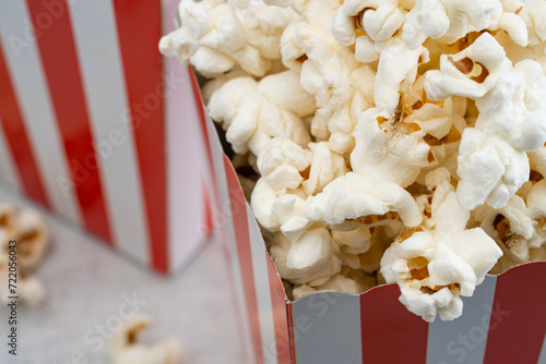 Popcorn in red and white striped paper box isolated on white background