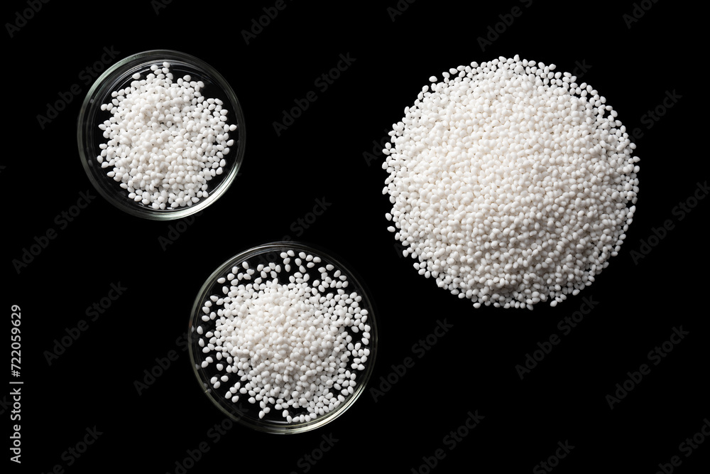 Top view of laboratory Petri dishes with samples of polymer plastic granules.