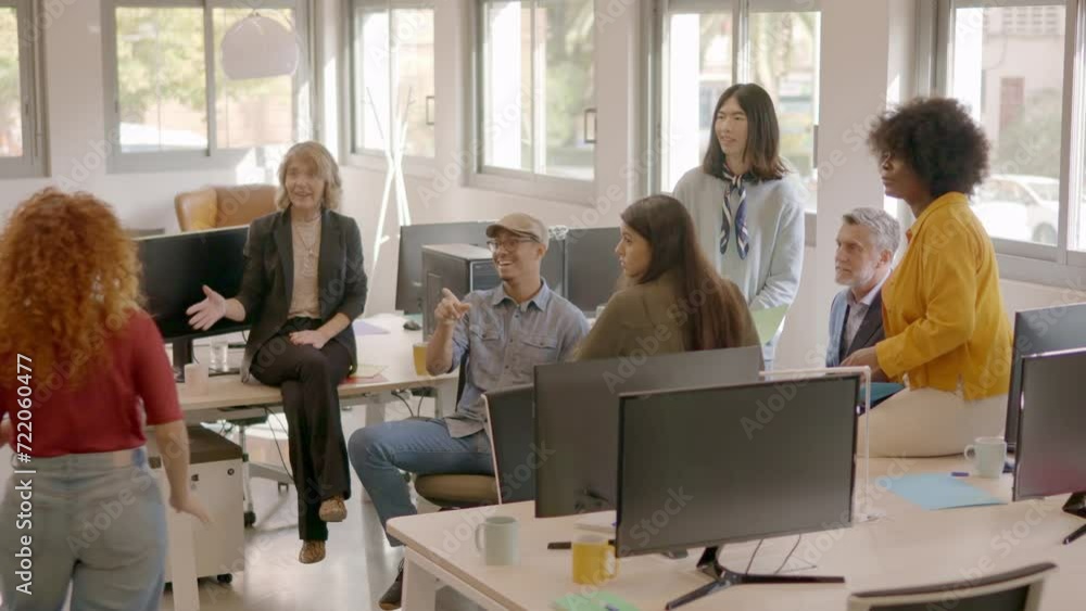 Woman giving good news to coworking mates and they celebrating Woman giving good news to coworking mates and they celebrating