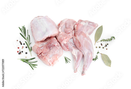 Fresh raw rabbit legs and spices isolated on white, top view photo