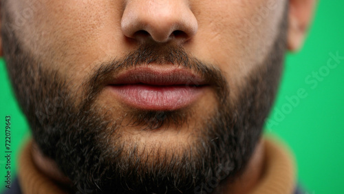 Man's mouth, close-up, on a green background