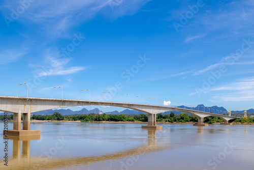 The third Thai–Lao border friendship bridge crossing over the Mekong river with blue sky, A bridge that connects Nakhon Phanom Province in Thailand with Thakhek, Khammouane Province in Laos.