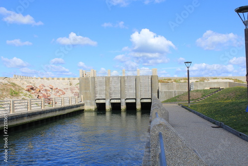 a modern fish passage of river durdent to the sea for reproduction at the french coast in veulettes-sur-mer in normandy and a blue sky © Angelique